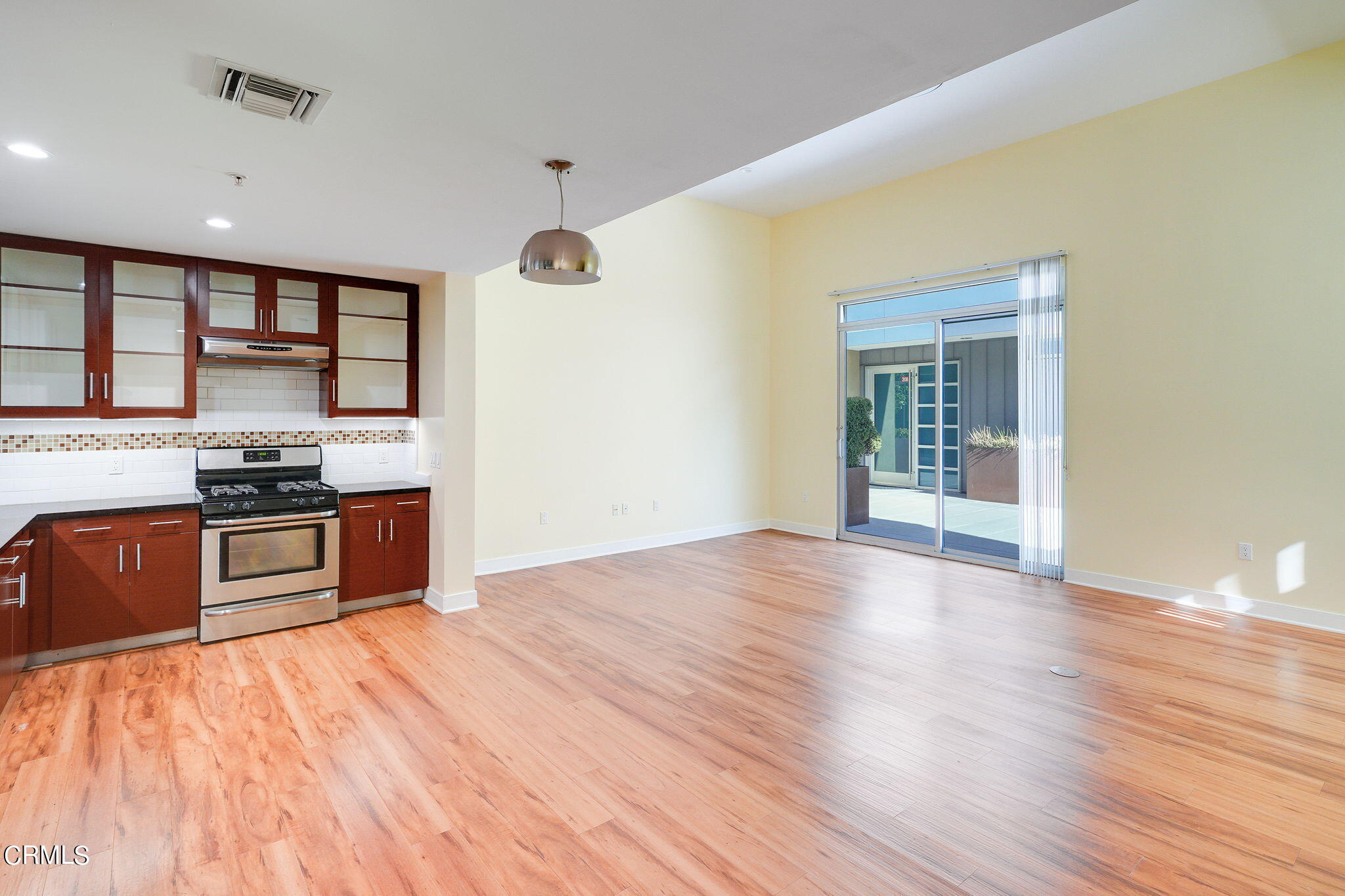 a kitchen with stainless steel appliances kitchen island wooden cabinets and granite counter tops