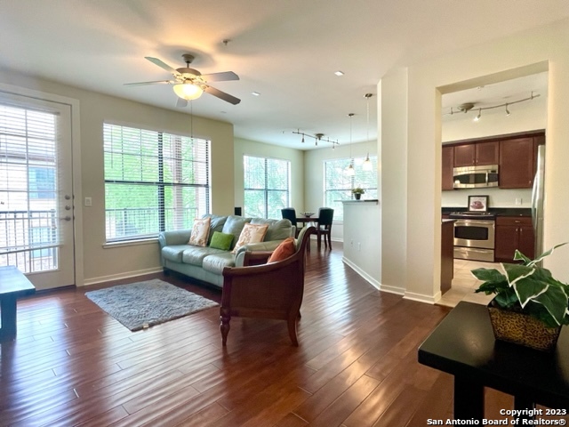 a living room with furniture window and wooden floor