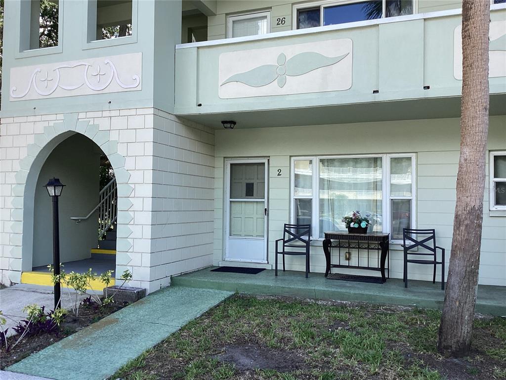 a front view of a house with outdoor seating