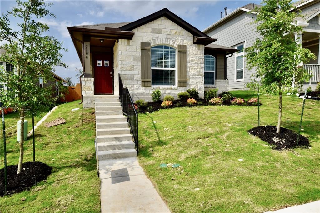 a front view of a house with garden