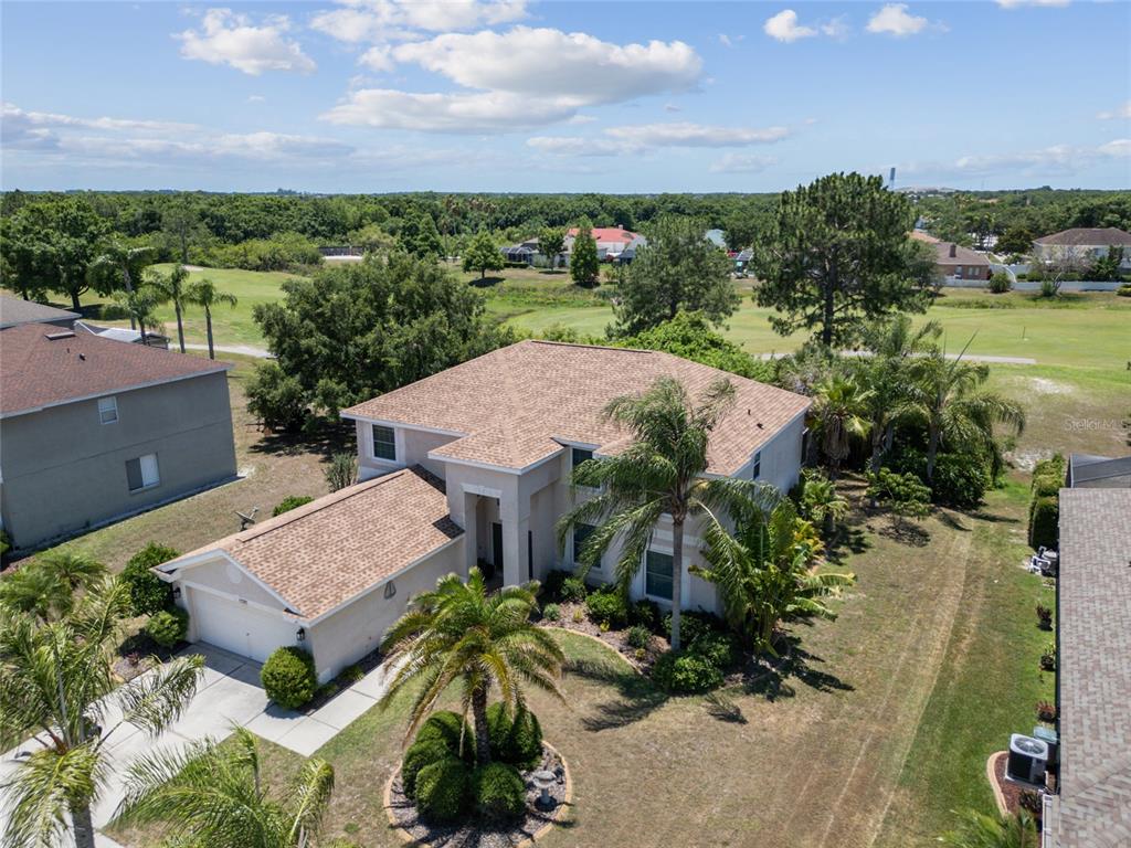 an aerial view of a house with garden space and street view