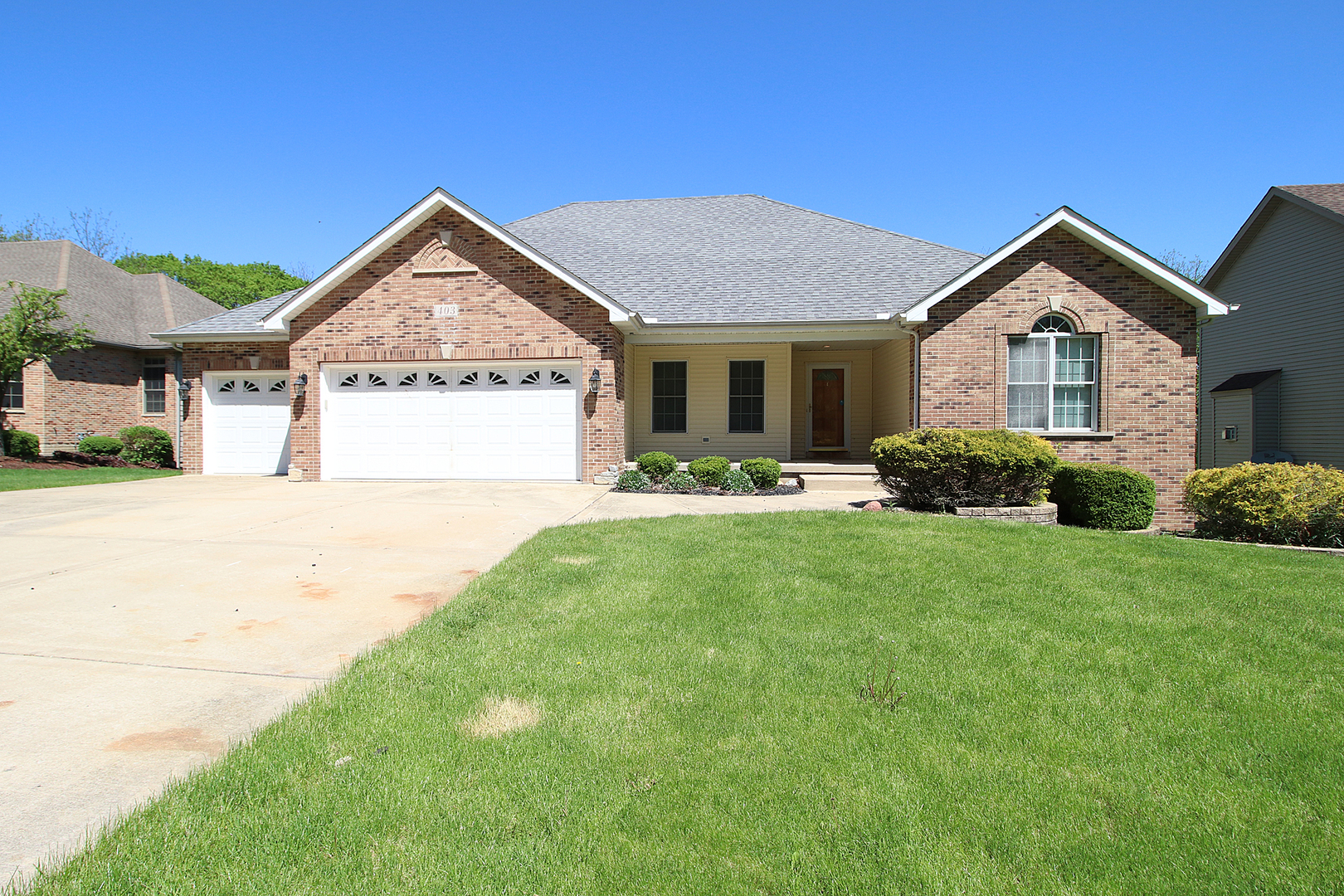 a front view of a house with a yard and porch