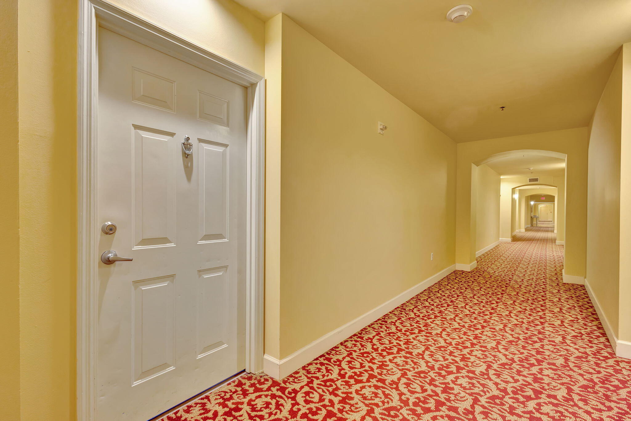 a view of a hallway with a wooden door