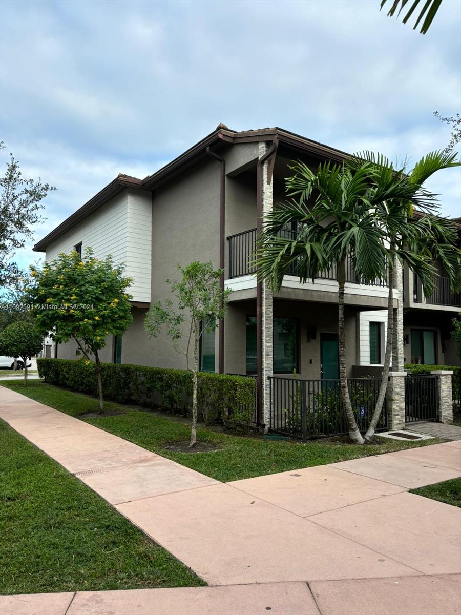 a front view of a house with garden