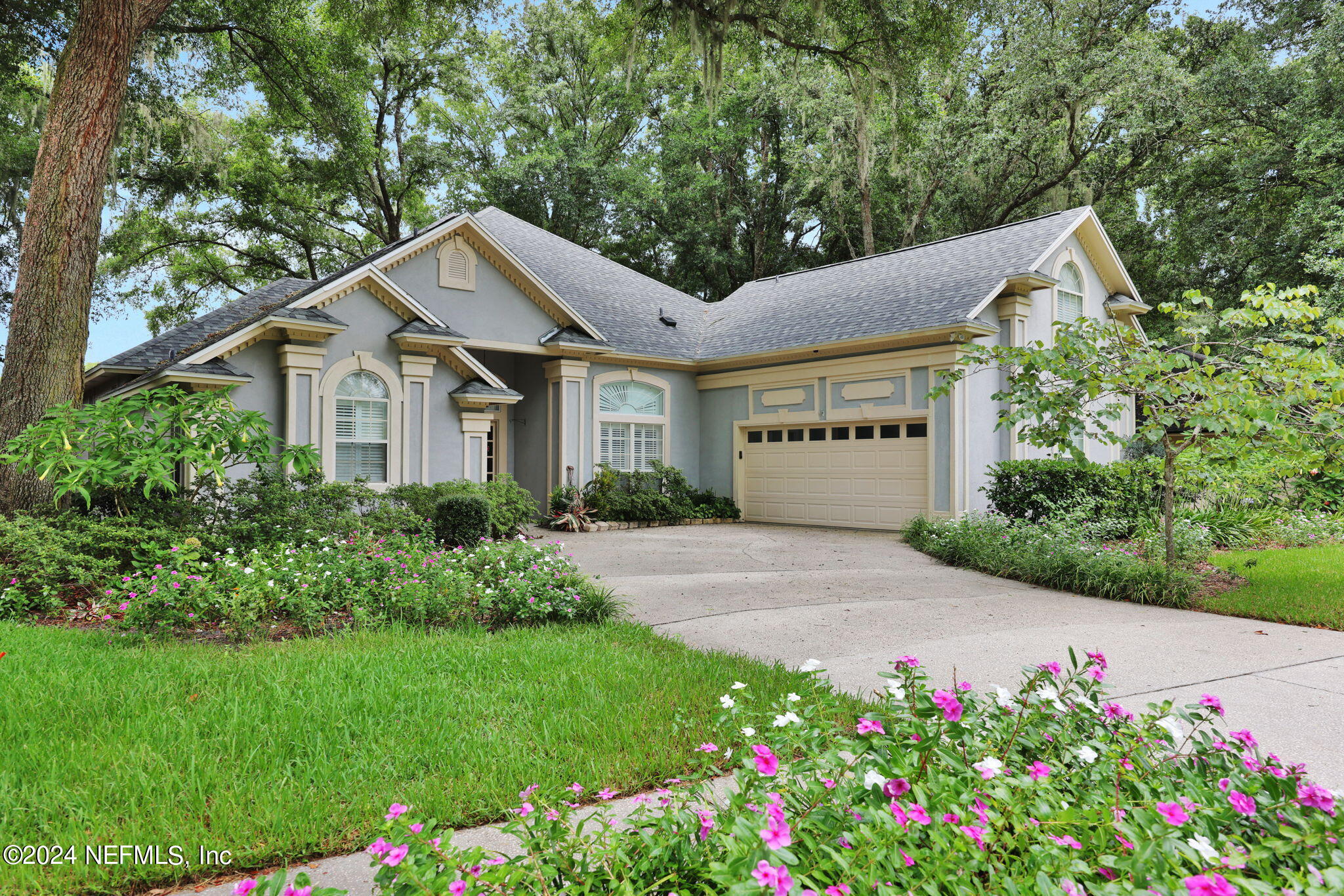 a front view of a house with a garden