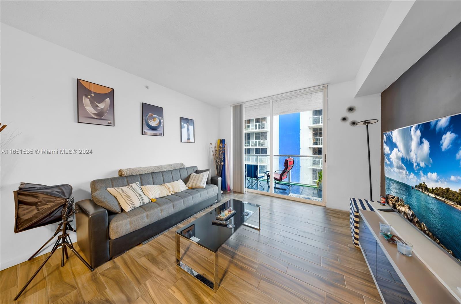 a living room with furniture and a flat screen tv