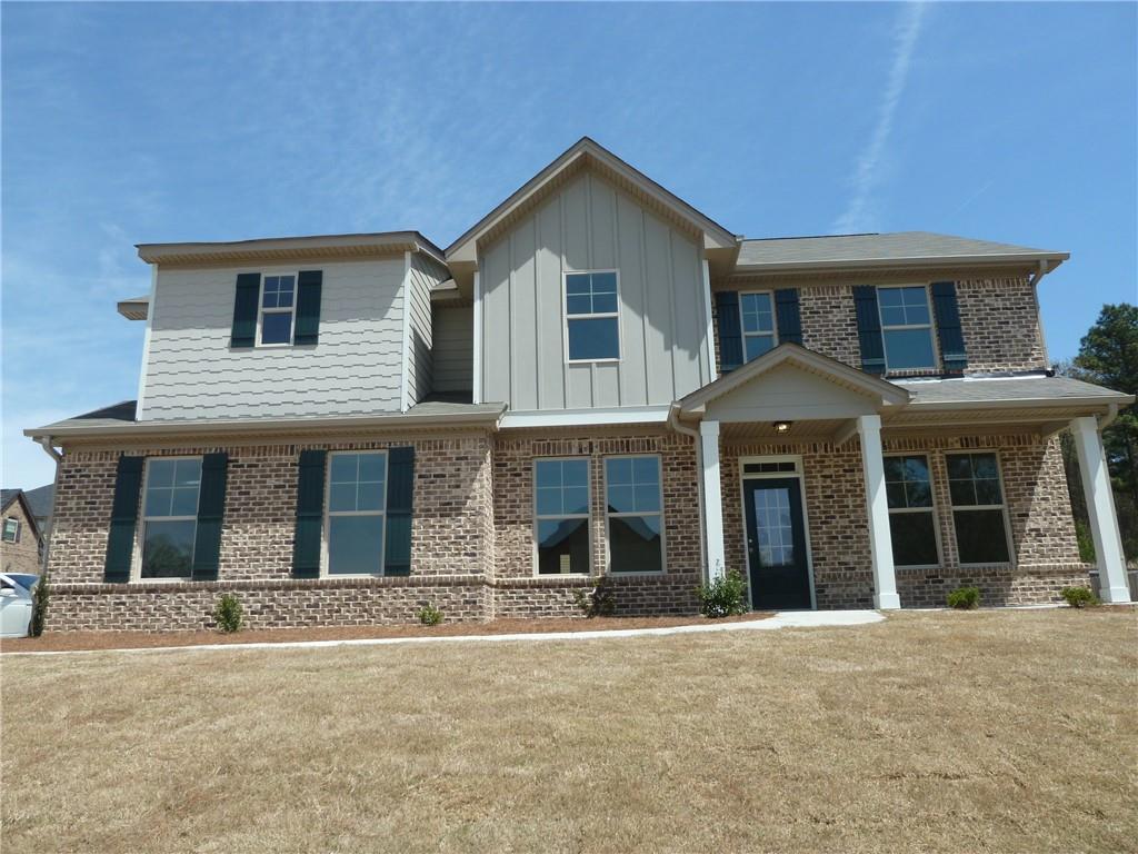 a front view of brick house with a yard