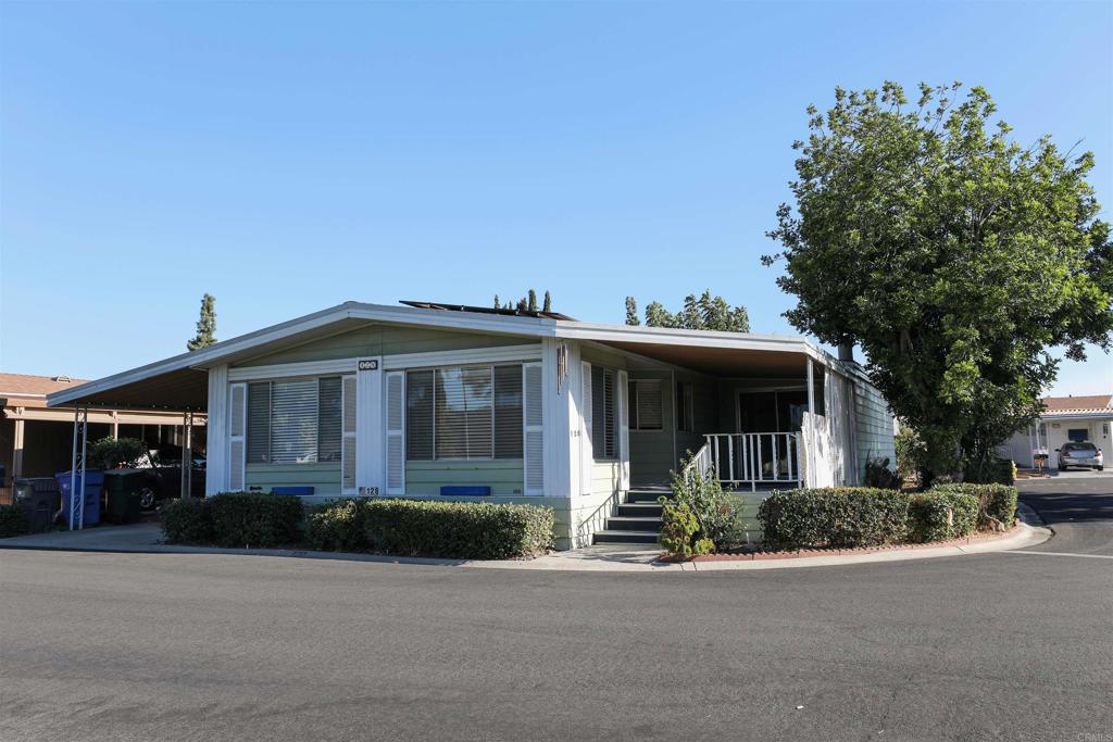 a front view of a house with a yard and trees