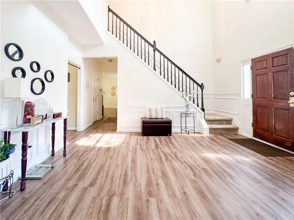 a view of entryway and hall with wooden floor