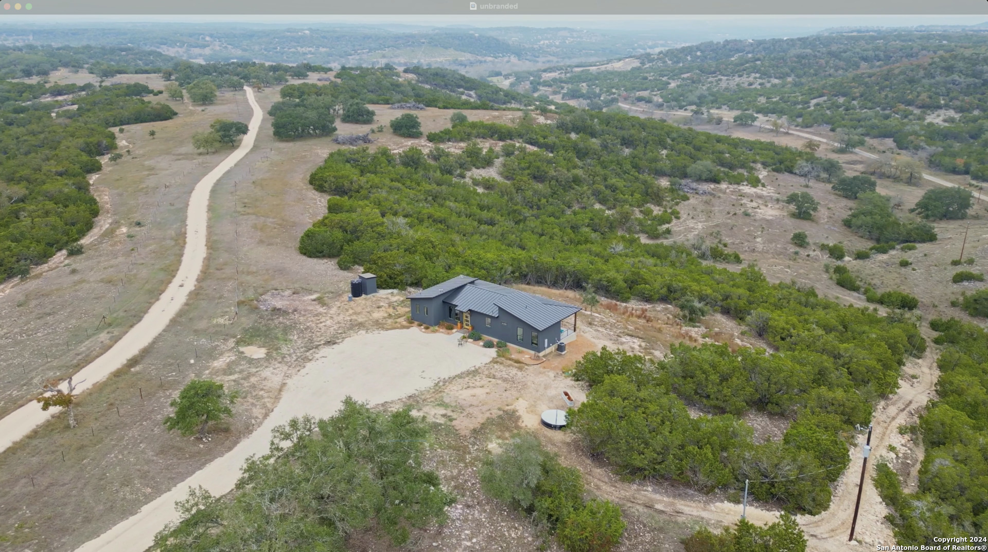 an aerial view of a house with a yard