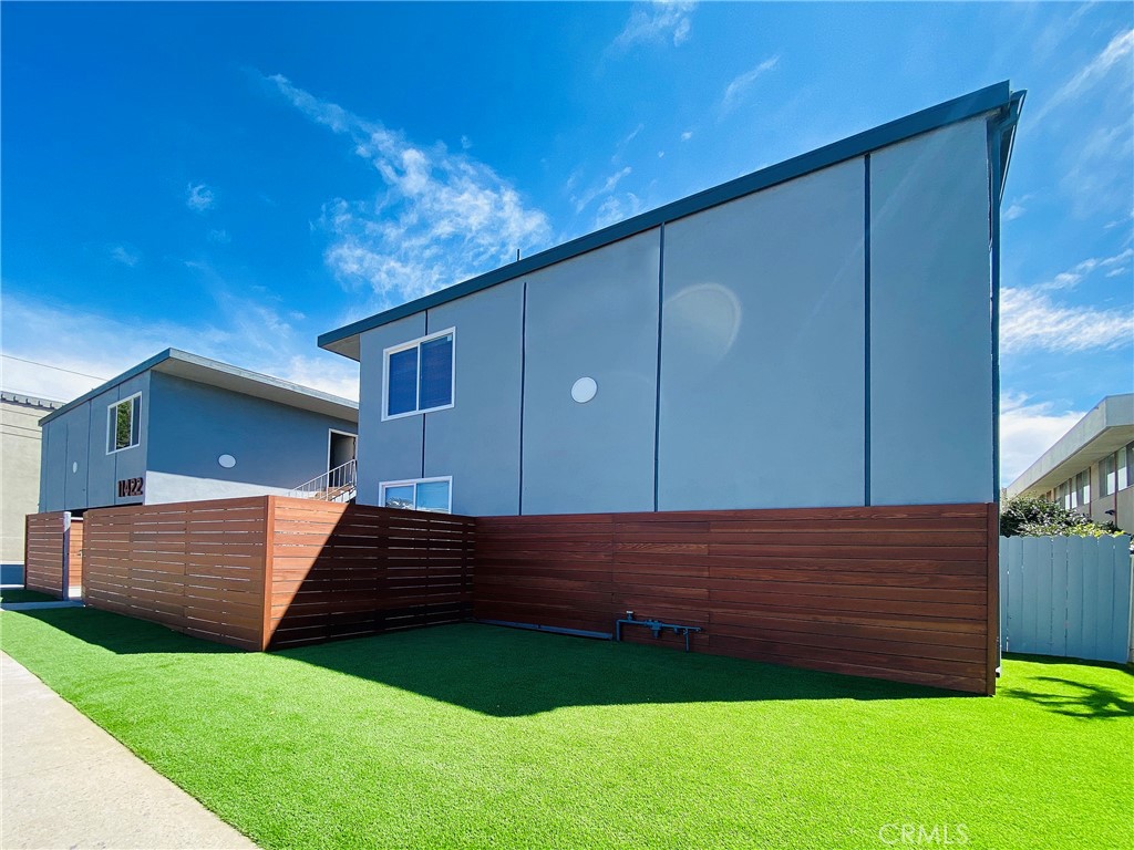 a view of a backyard with wooden fence