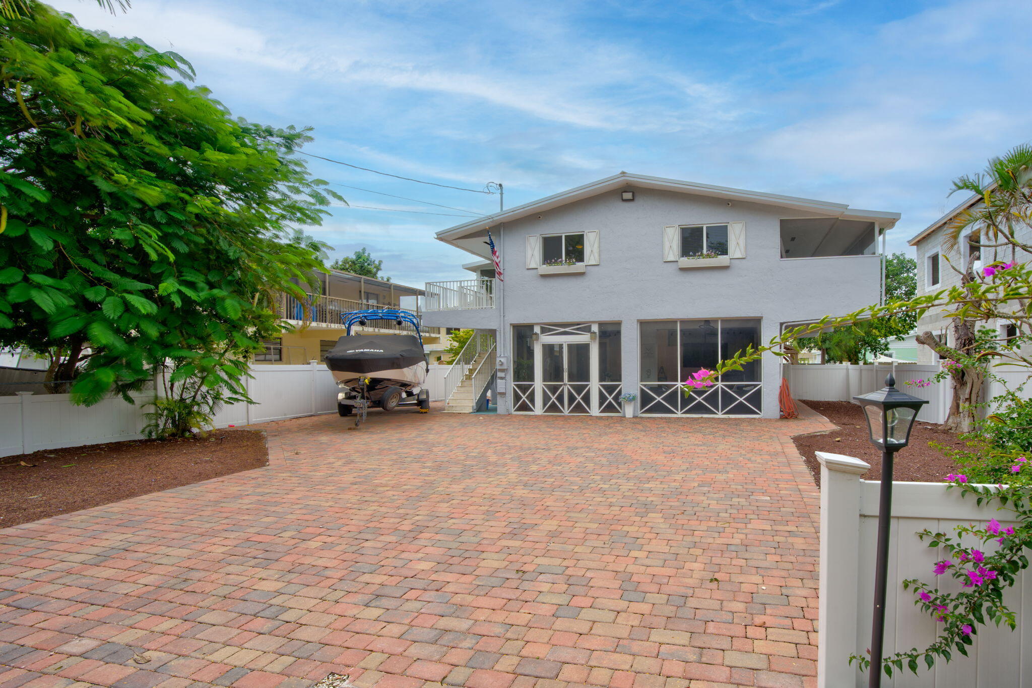 a view of an house with backyard and sitting area