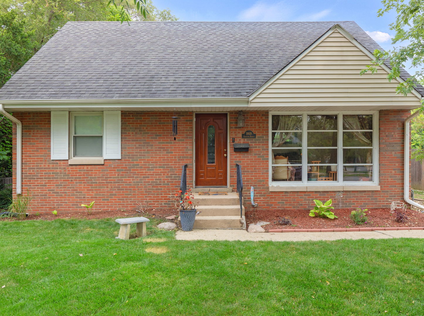 a front view of a house with garden