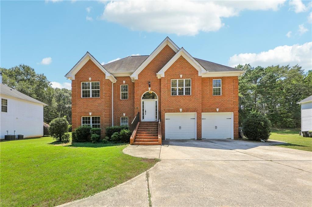 a front view of house with yard and green space