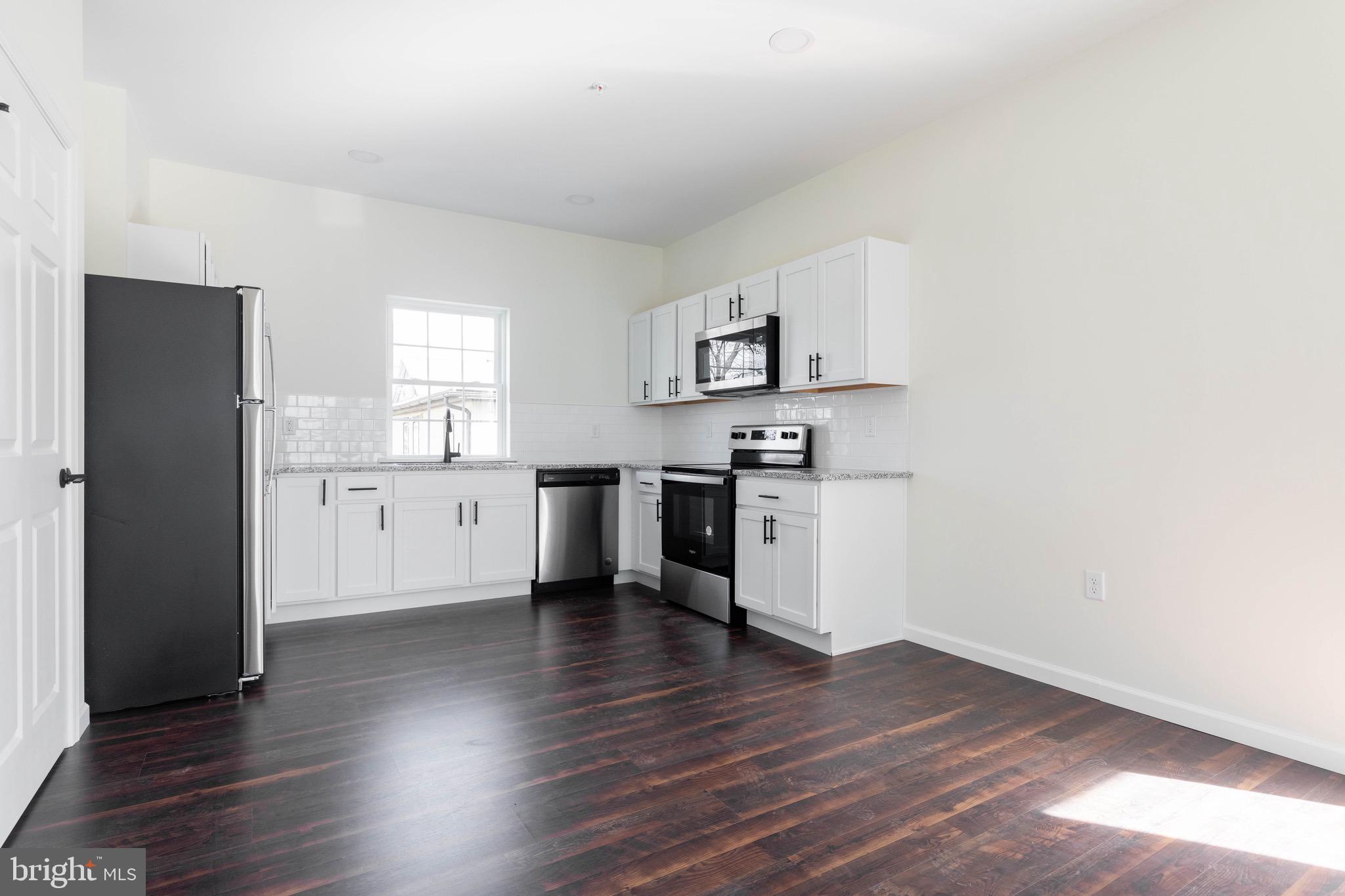 a view of kitchen with wooden floor