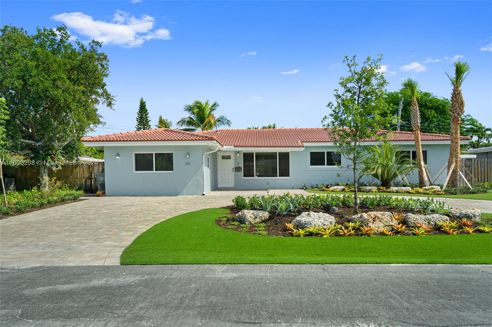 a front view of a house with a garden