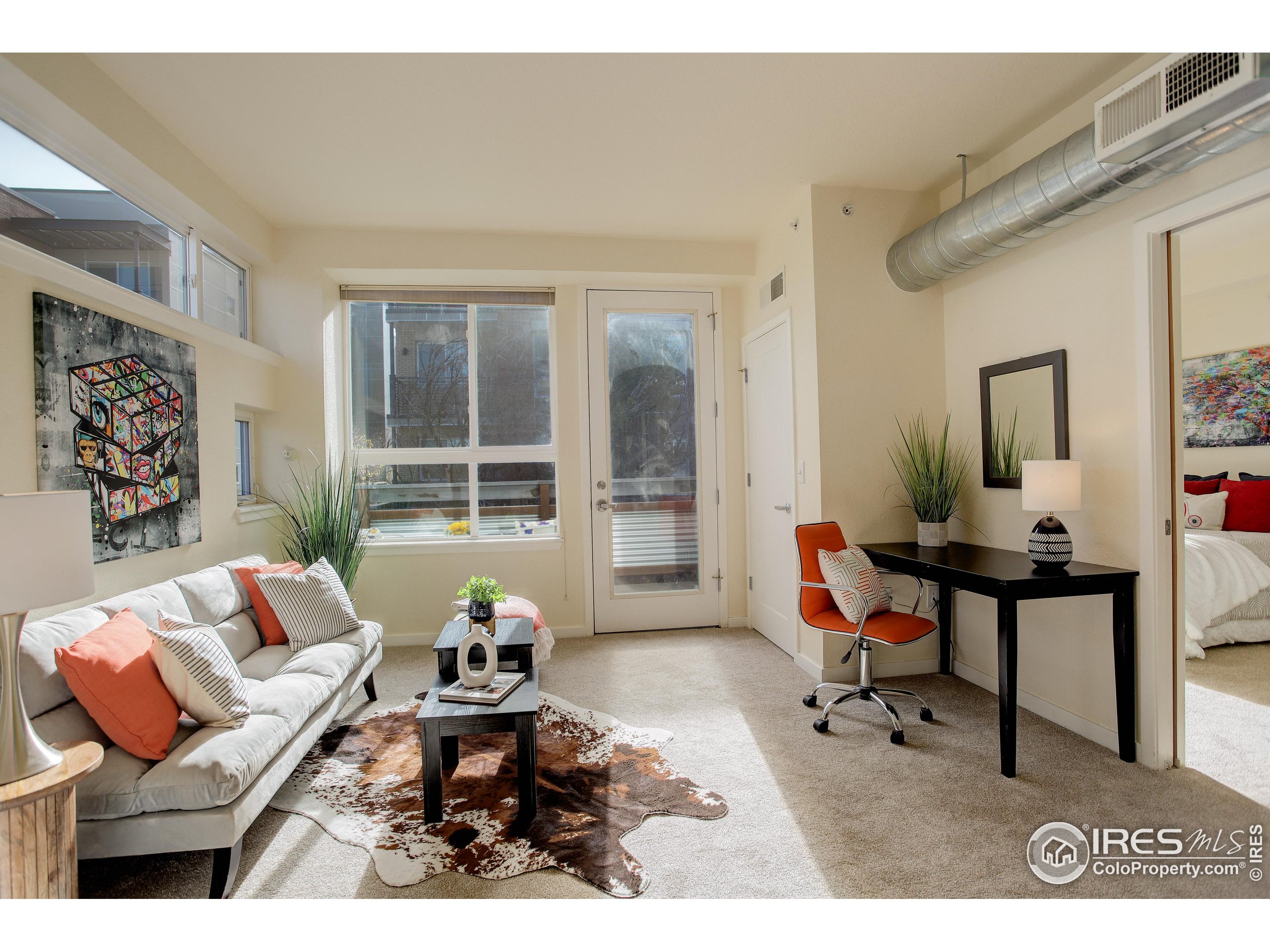 a living room with furniture a window and a table