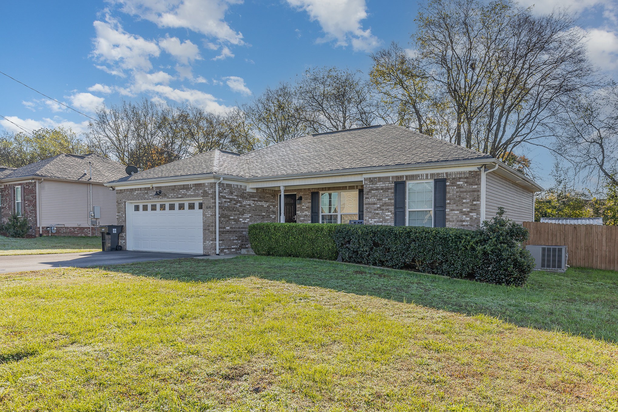 a view of a house with a yard and tree s