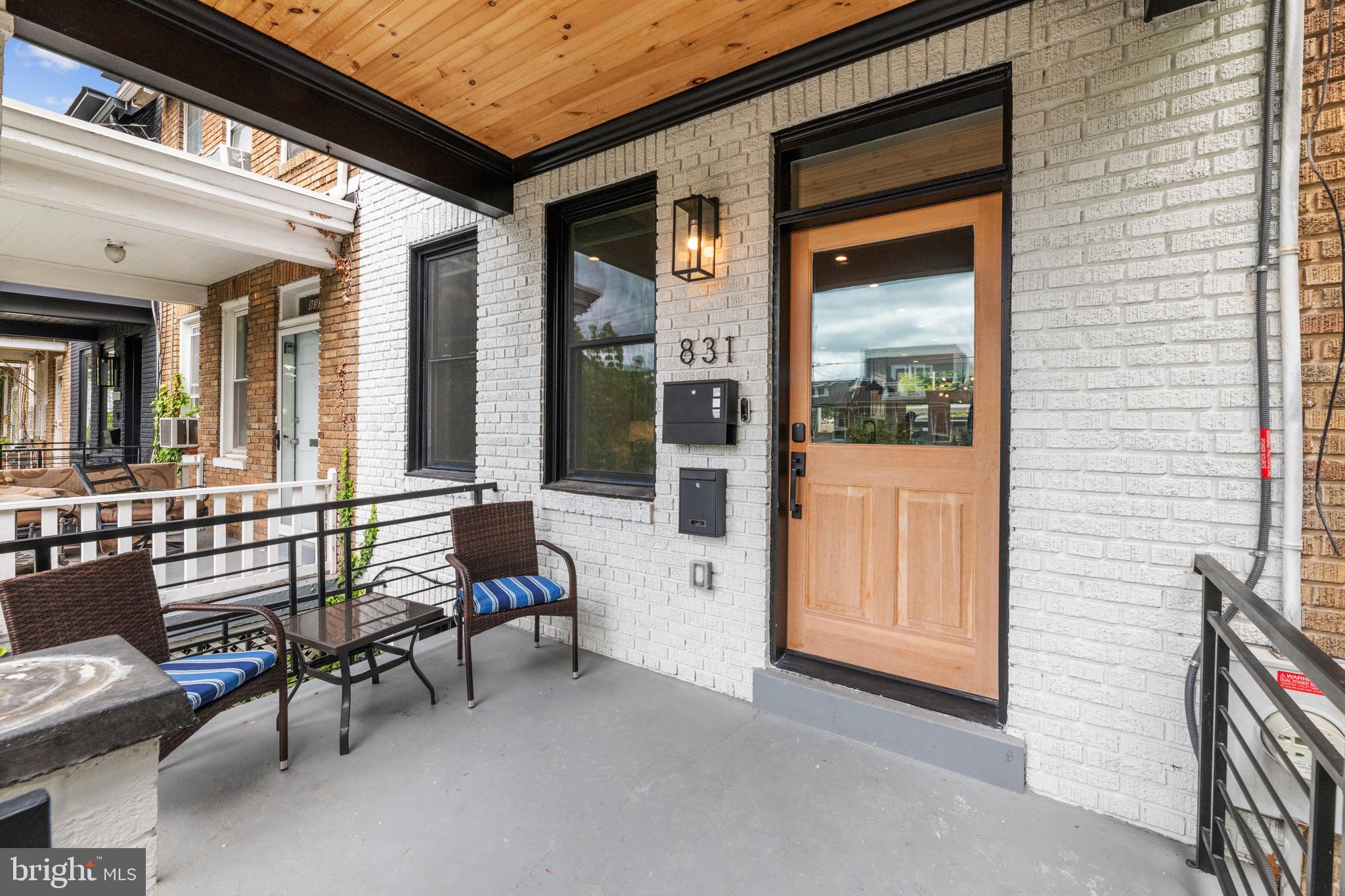 a balcony with furniture and next to a window