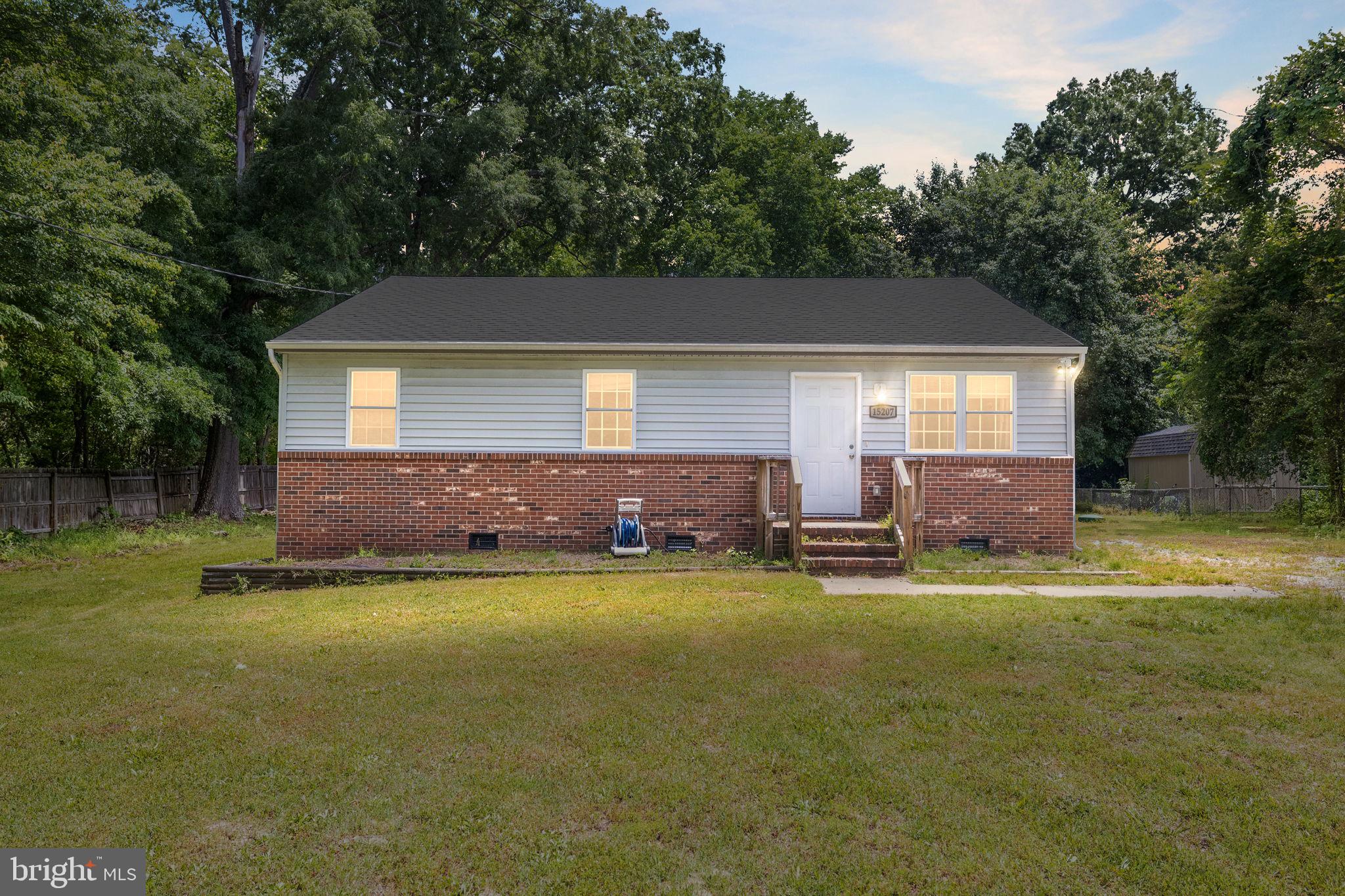 a view of a house with a yard and sitting area