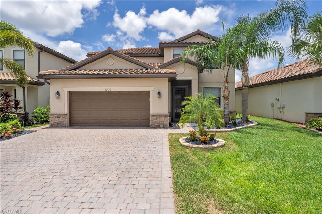 Mediterranean / spanish house featuring a garage and a front yard