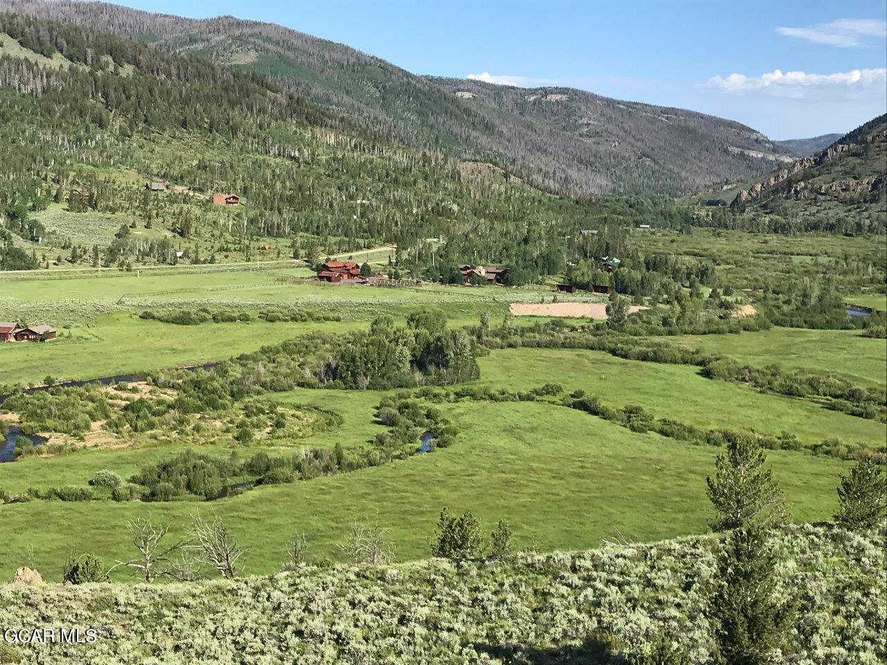 a view of a lush green hillside and houses