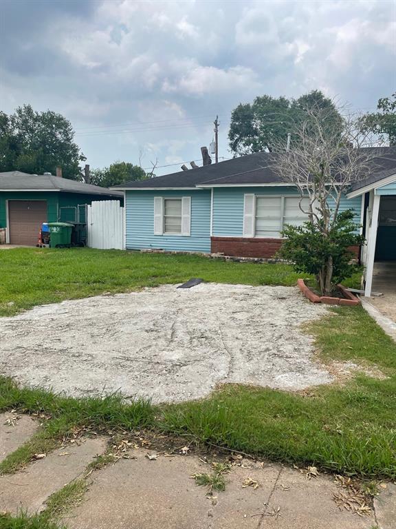 a front view of a house with a yard and a garage