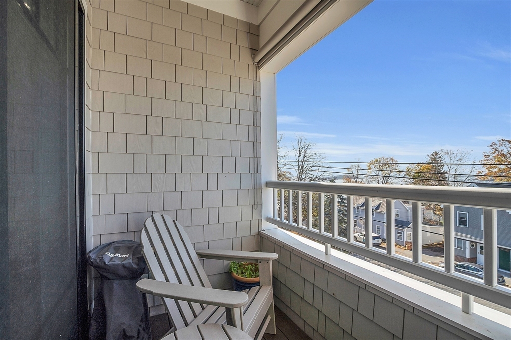 a view of a balcony with chairs