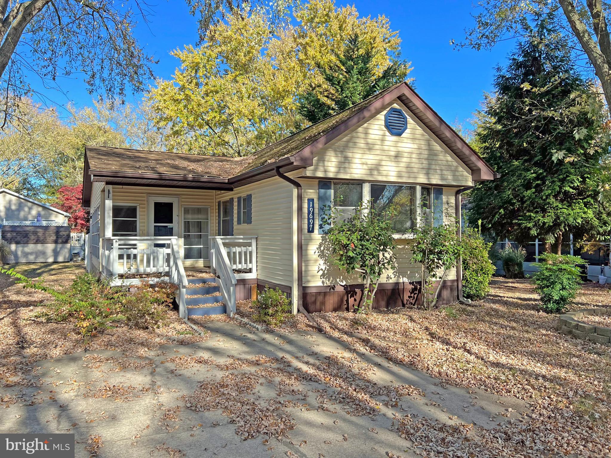 a front view of house with a yard and seating space