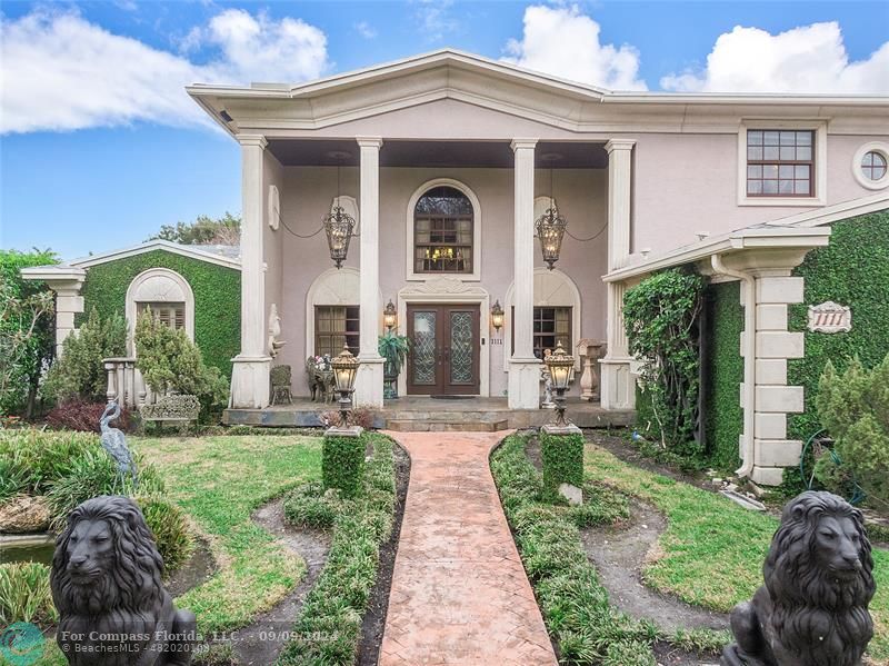 a front view of a house with a garden