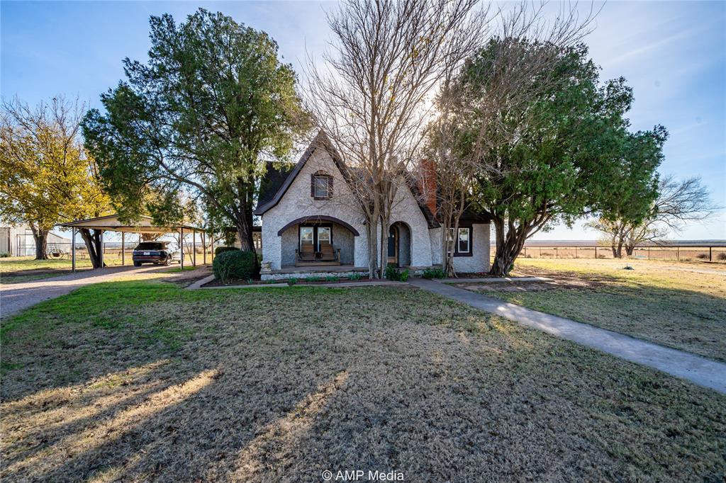 a view of a house with yard and tree s