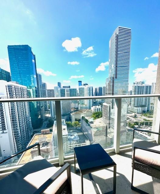 a view of a balcony with chair and wooden floor