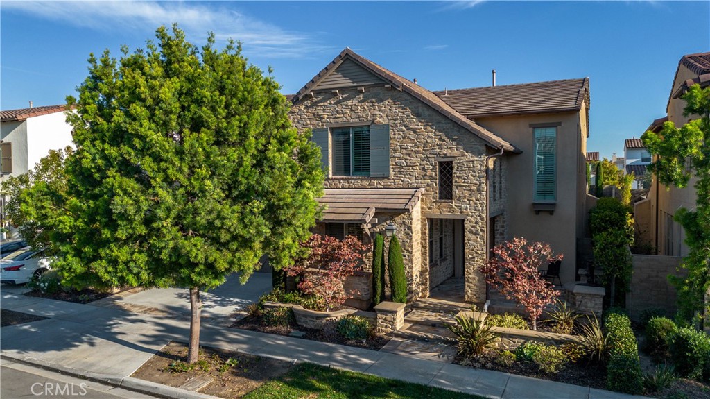 front view of a house with a tree