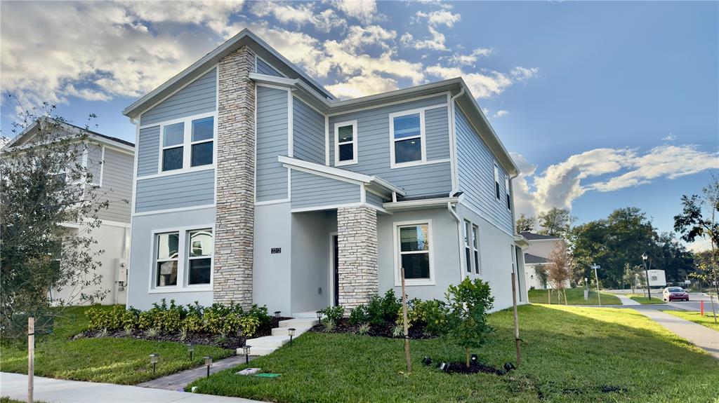 a front view of house with yard and green space