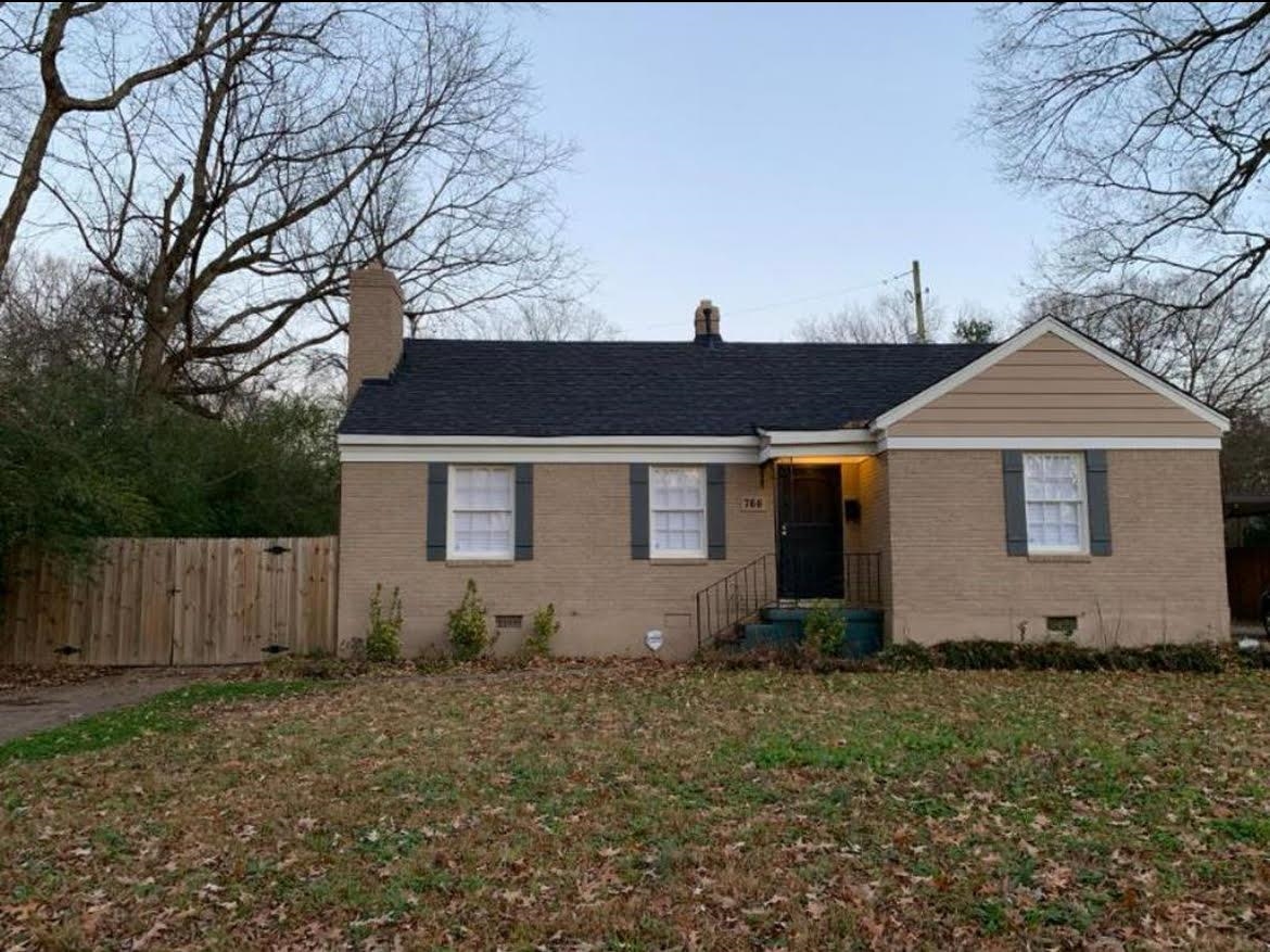 a front view of house with a garden