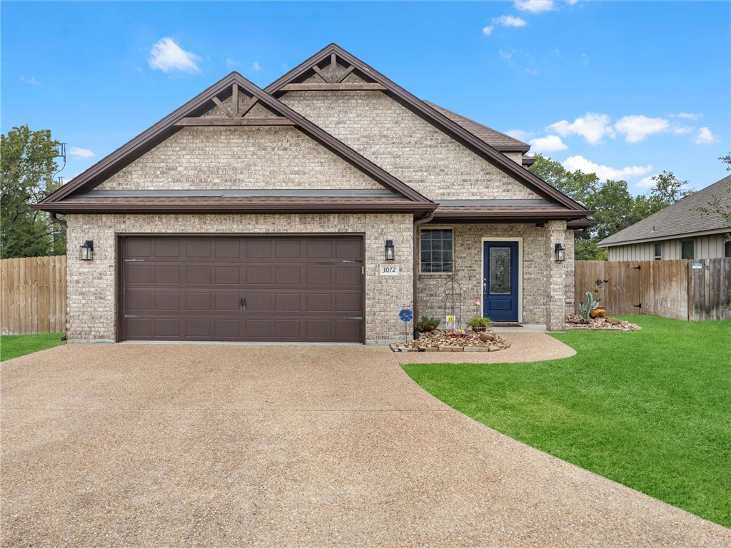 a front view of a house with garage and yard