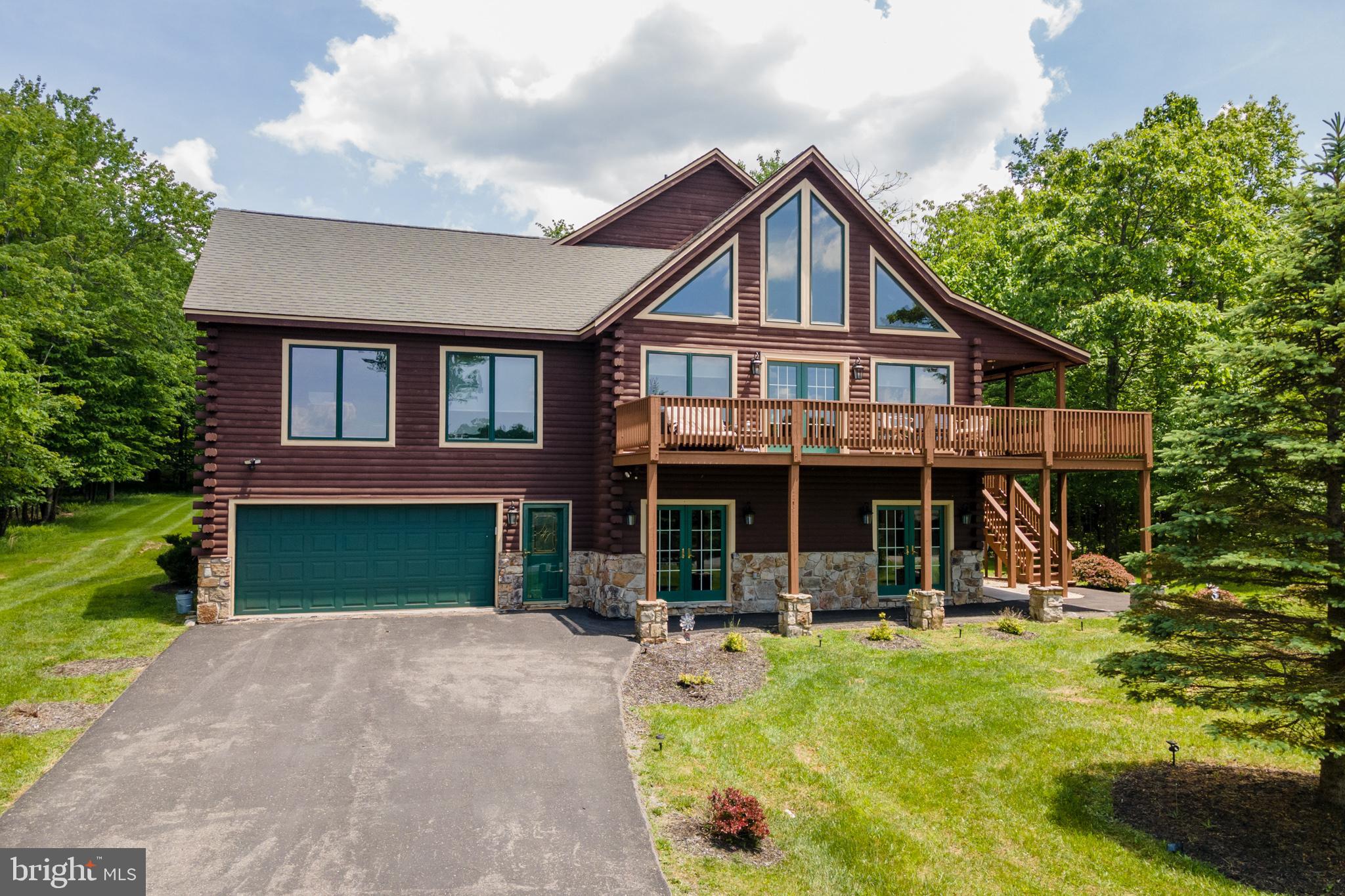 a front view of a house with swimming pool and porch