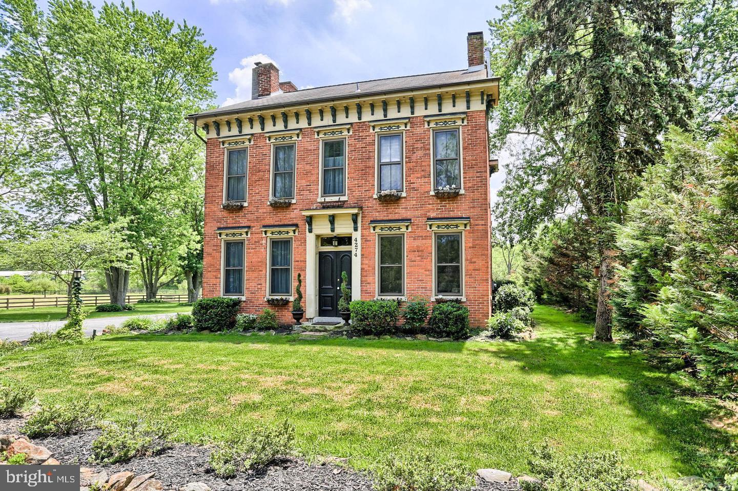 a view of a brick building next to a yard