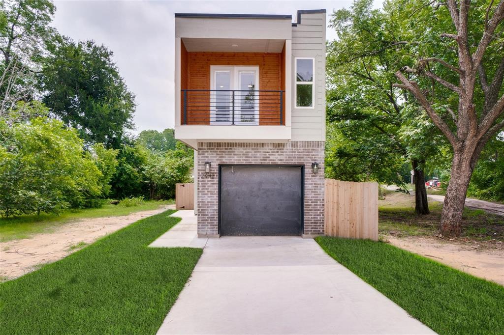 a front view of a house with a garden and yard