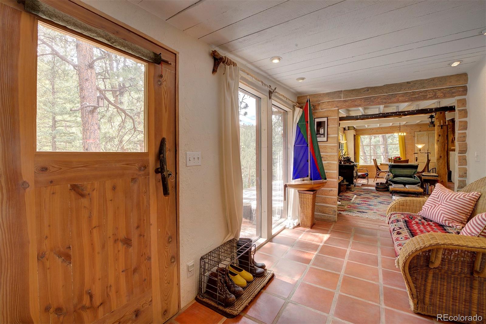 a living room with furniture a flat screen tv and a window