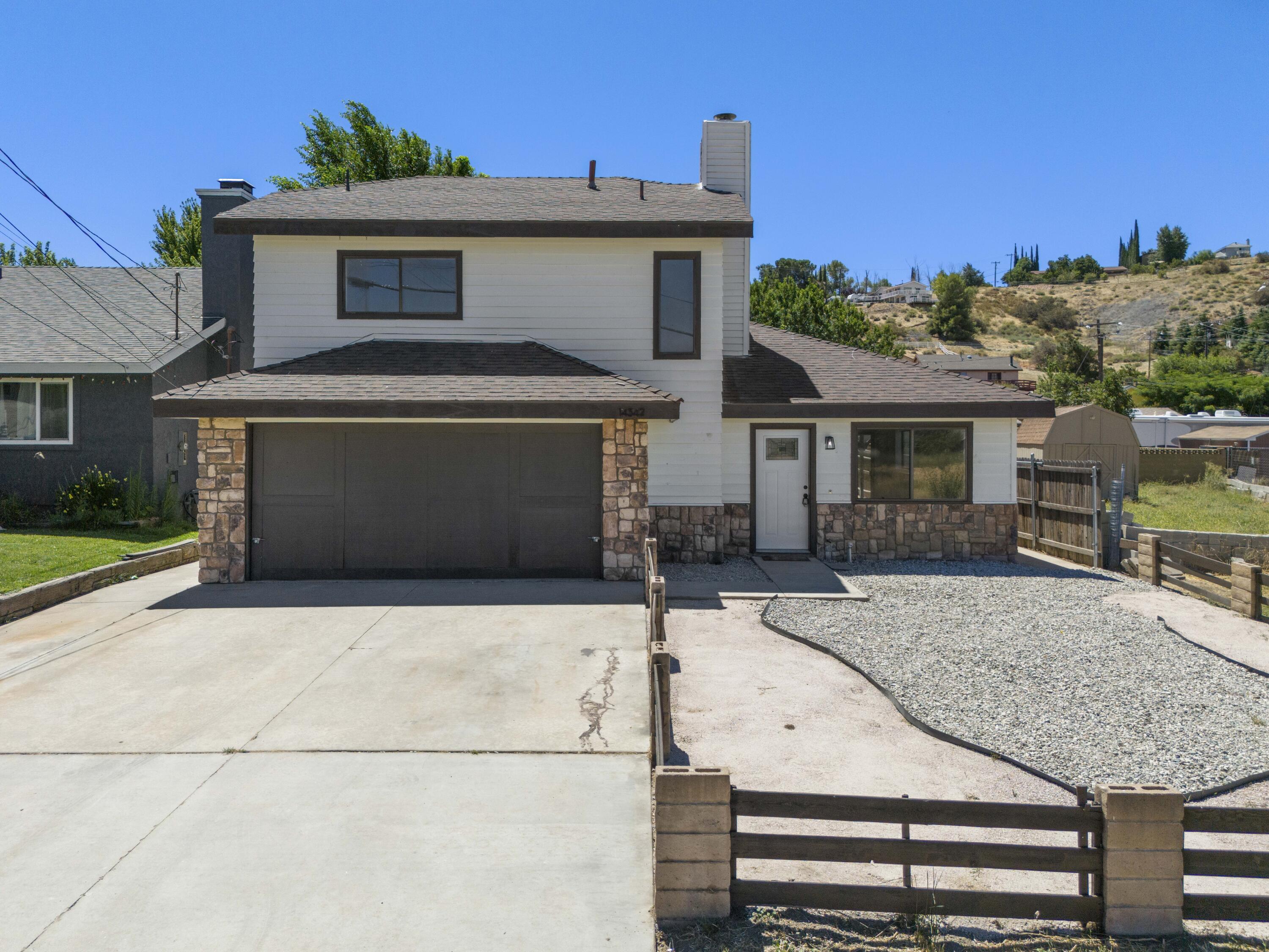 a front view of a house with garage