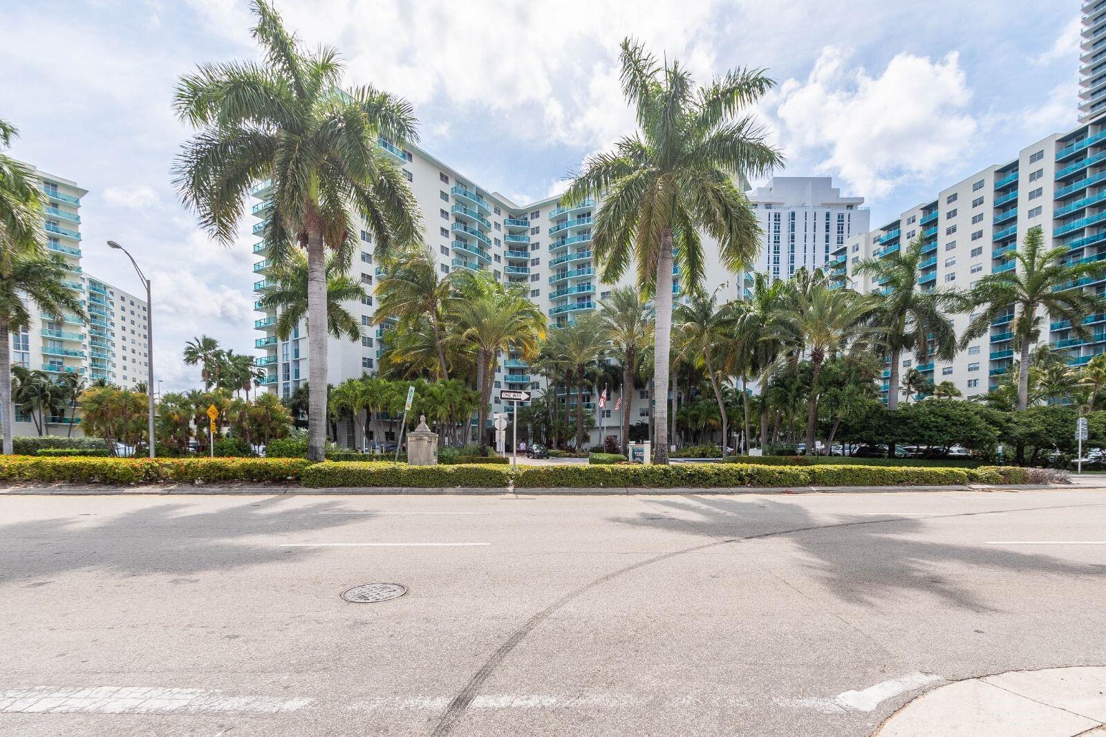 a view of a multi story building in front of a yard