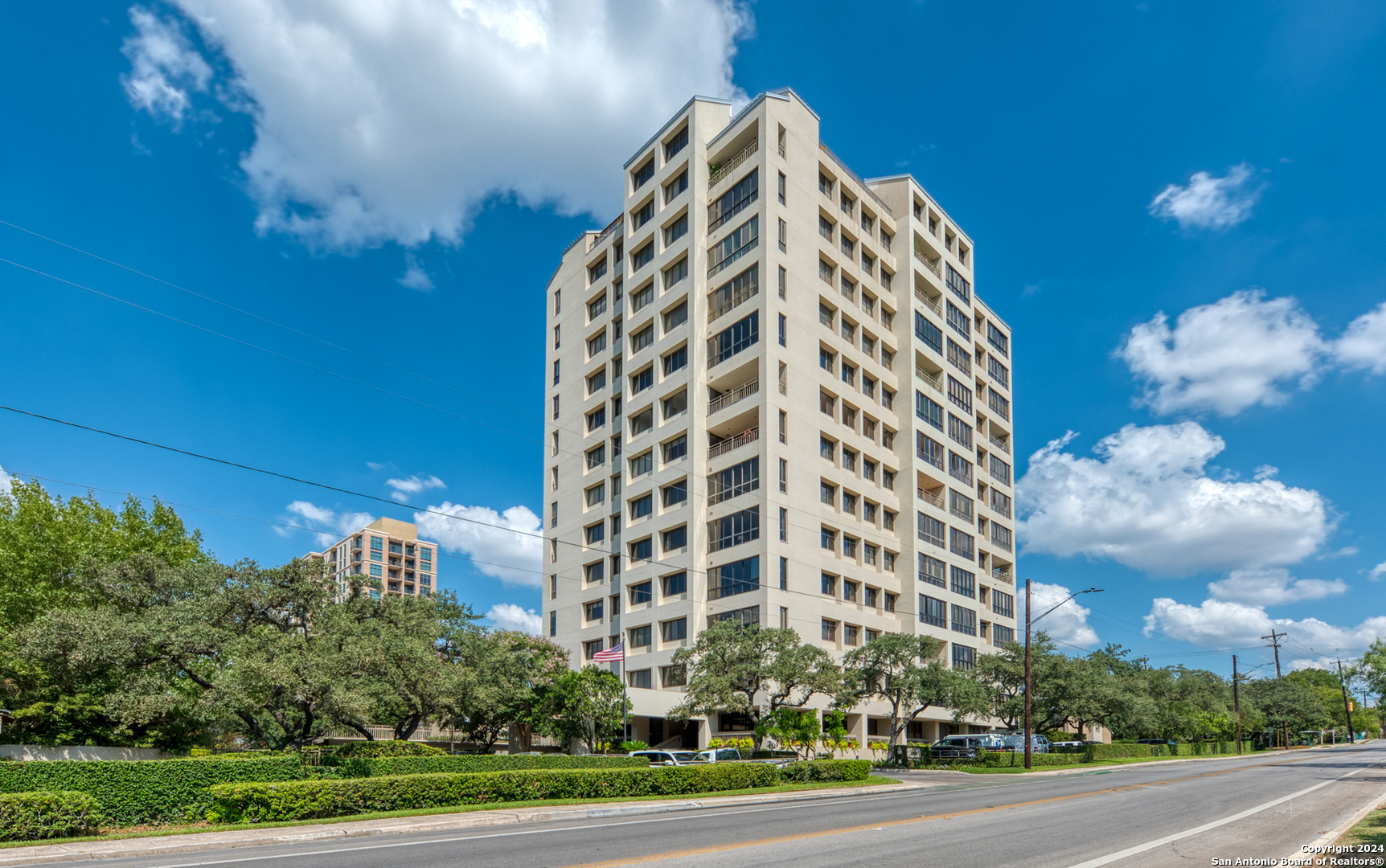 a view of a tall building next to a city