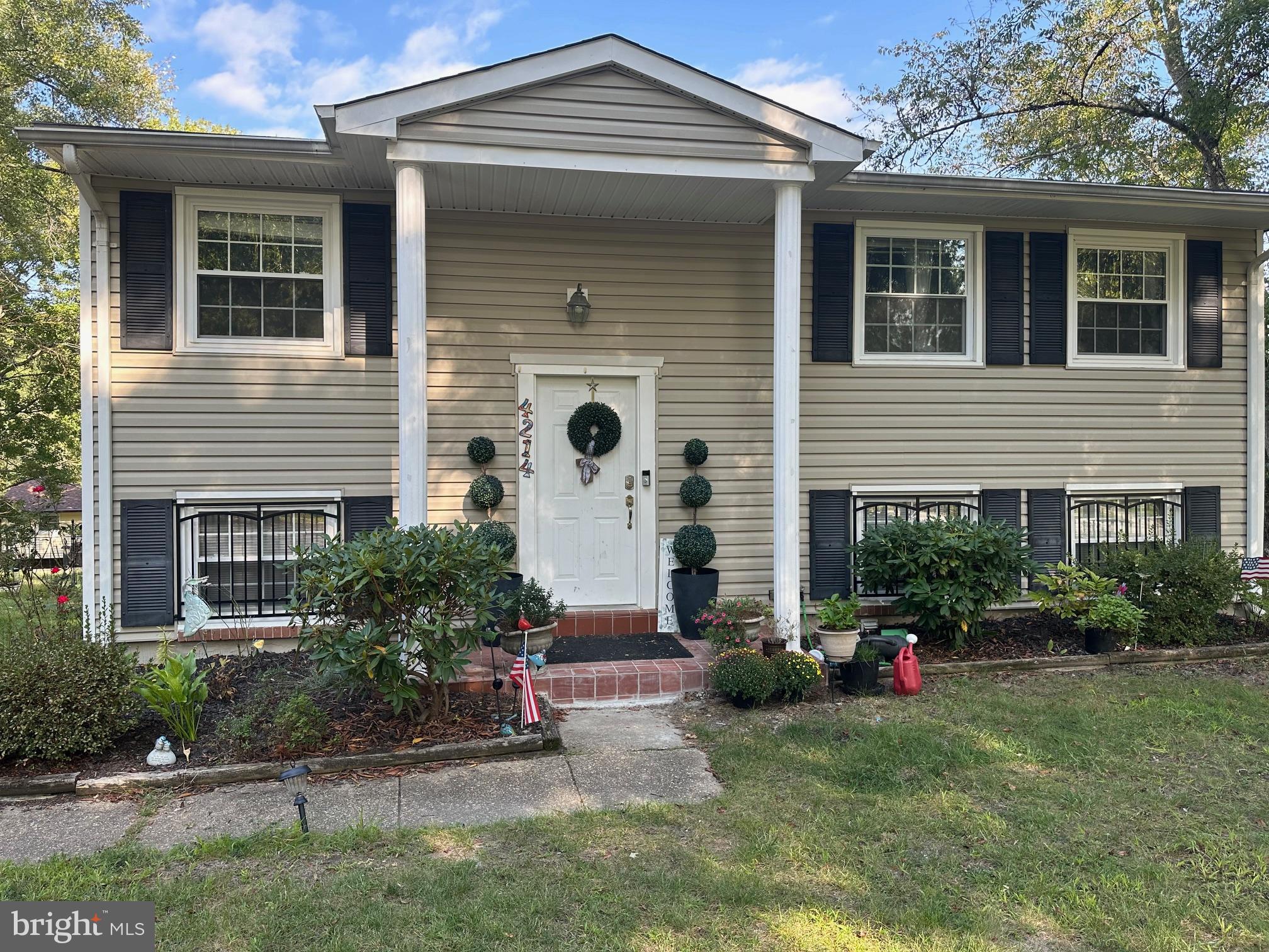 a front view of a house with a yard and a garage