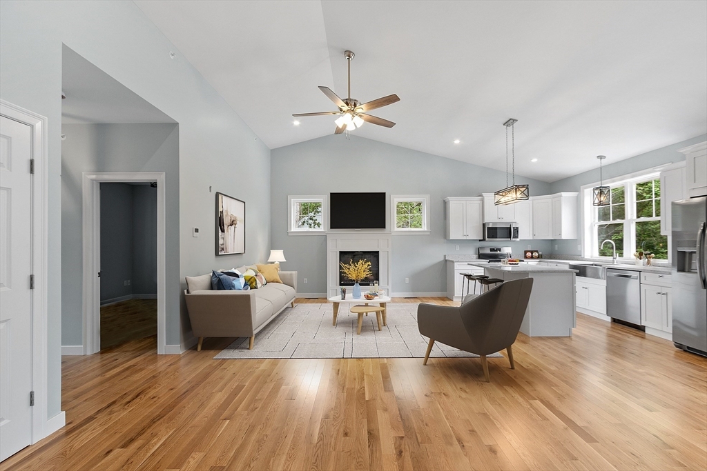 a living room with furniture a fireplace and a flat screen tv