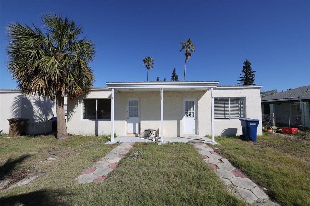 a view of a house with a yard and plants