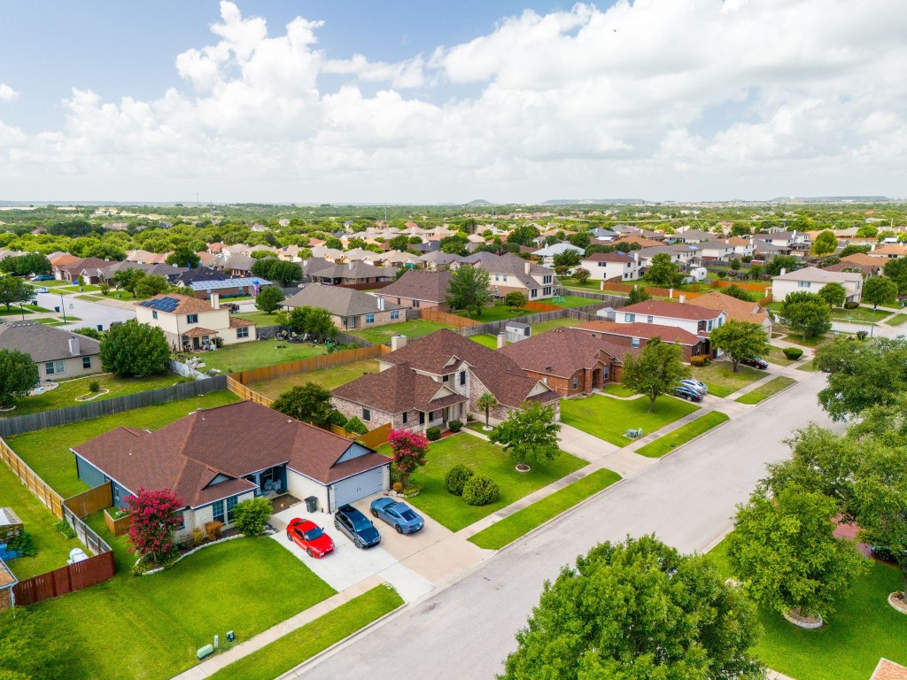 an aerial view of a houses with garden