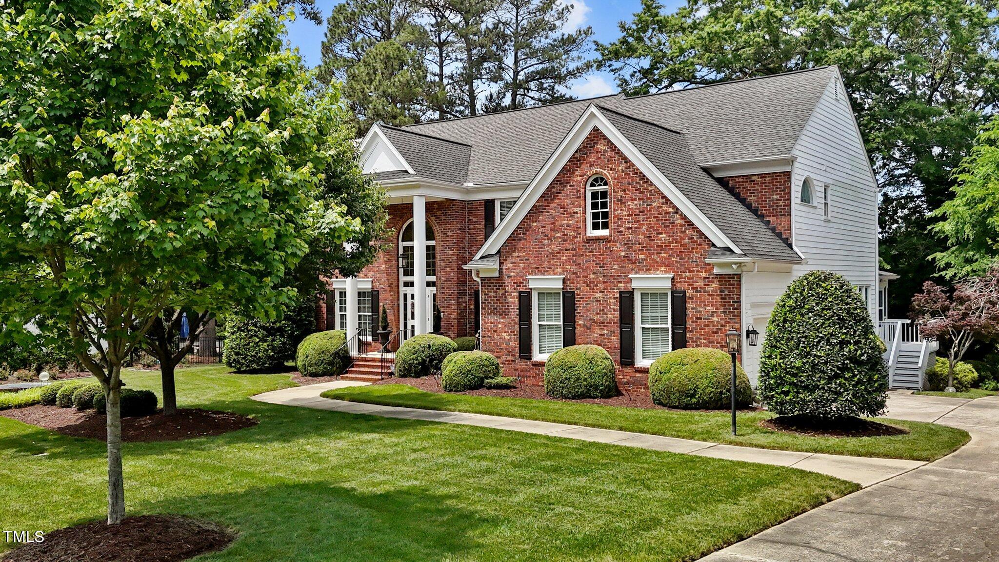 a front view of house with a garden