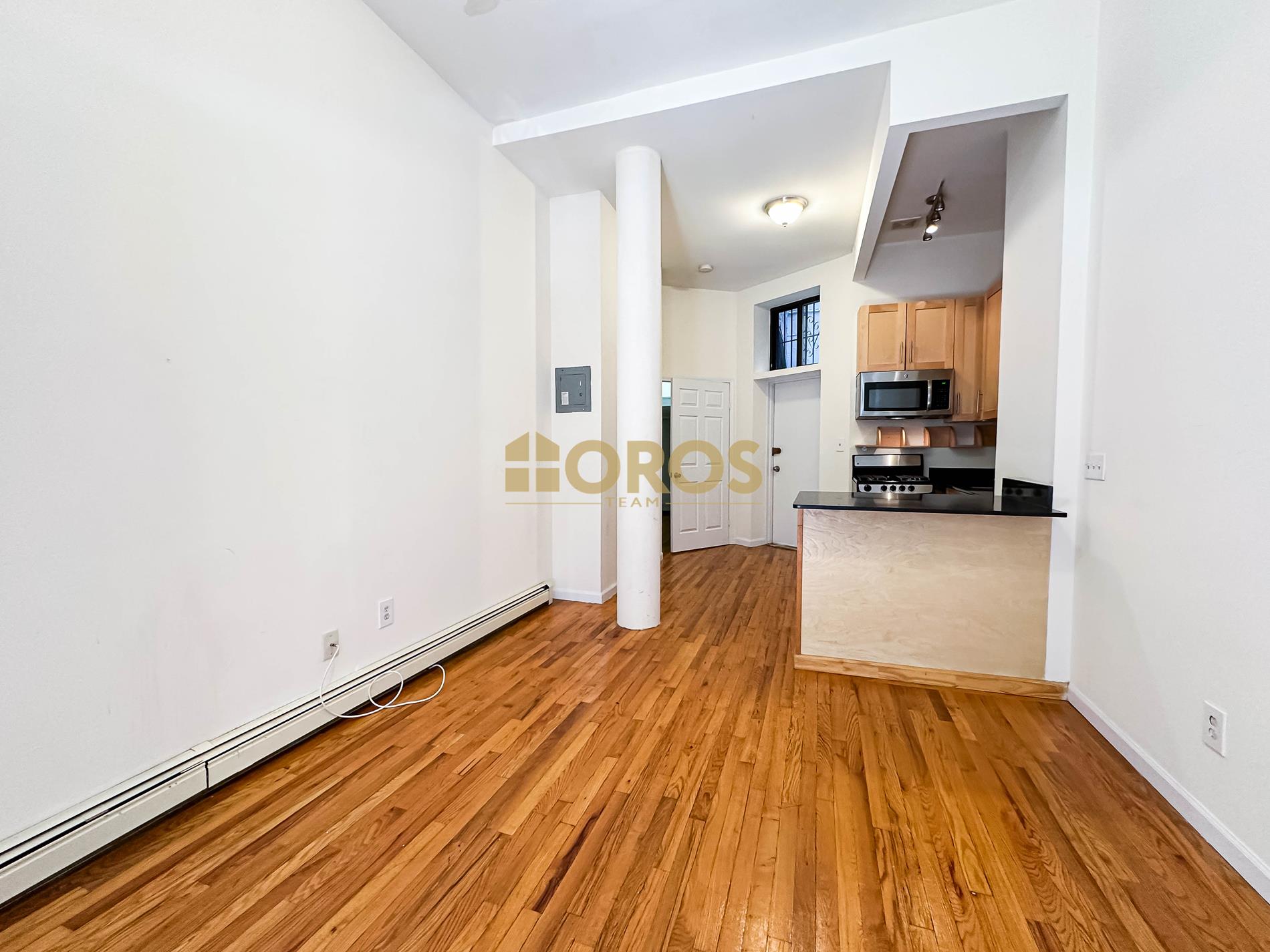 a view of a kitchen with wooden floor