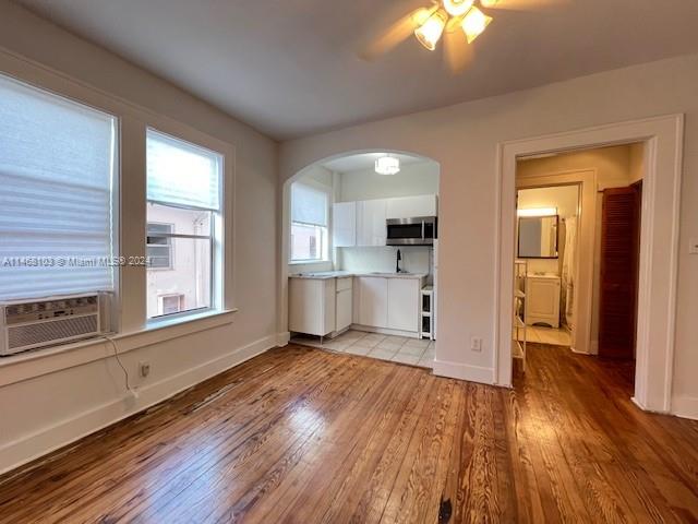 a view of a kitchen with wooden floor and a kitchen